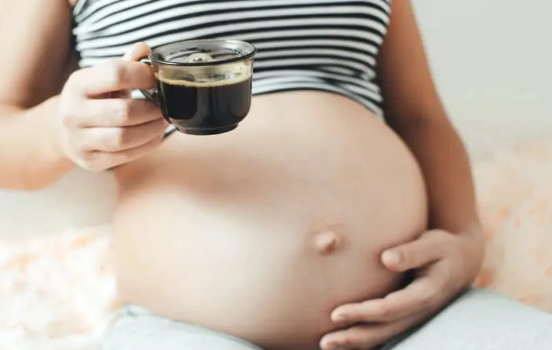 A woman drinking coffee during pregnancy